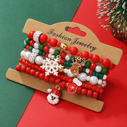 Christmas bracelet set with reindeer bells, Christmas tree beads, and woven polymer clay.